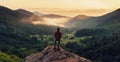 Man standing on top of cliff at sunset Royalty Free Stock Photo