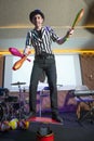 Man standing on top of cylinders and juggling glass bottles, one bottle broke. A series of drawings about the circus. Juggle clubs