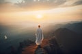 a man standing on top of a mountain looking at the sunset Royalty Free Stock Photo