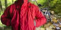 Man standing in travel hiking red jacket in woods Royalty Free Stock Photo