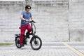 Man standing upright riding electric bike Royalty Free Stock Photo