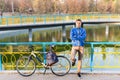 Man standing waiting with his bicycle