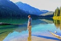 Man standing in water with feet and lokking at mountain