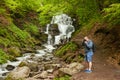 Man standing at the waterfall and making photos Royalty Free Stock Photo