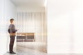 Man in white living room with cabinet Royalty Free Stock Photo