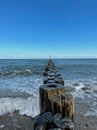 Man standing on wooden breakwater, Baltic sea Royalty Free Stock Photo