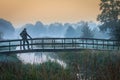 Man standing on wooden bridge at dawn Royalty Free Stock Photo