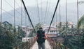 Man standing on wooden suspension bridge in a mountain village of Laos Royalty Free Stock Photo