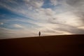 Man stands alone atop a Dune in the Sahara Desert Royalty Free Stock Photo