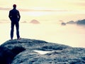 Beautiful moment the miracle of nature. Colorful mist in valley. Man hike. Person silhouette stand Royalty Free Stock Photo