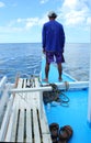 A man stands on the bow of a boat on the sea, Philippines Royalty Free Stock Photo