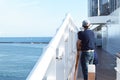 A man stands on the deck of a cruise ship and looks at the shore on a Sunny day Royalty Free Stock Photo