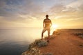 Man stands on the edge of the abyss and looks at the sea Royalty Free Stock Photo