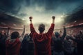 A man stands in front of a crowd of people, taking charge and inspiring unity and excitement, Rear view of cheering football fans Royalty Free Stock Photo