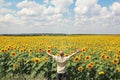 Man stands in front of summer sunflower field Royalty Free Stock Photo