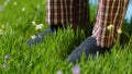 Man stands on the grass in Slippers. Male feet in sneakers on the grass Royalty Free Stock Photo