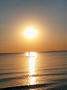 a man stands on his surfboard in the water at sunset Royalty Free Stock Photo