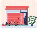 Man stands near garage with opening door and bicycle. Storage space for bike, room for transport Royalty Free Stock Photo