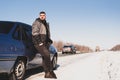 Man stands near his broken car in winter Royalty Free Stock Photo