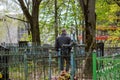 A man stands near the old grave of a relative in an abandoned cemetery Royalty Free Stock Photo