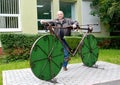 The man stands near a topiarny sculpture Bicycle. Svetlogorsk, Kaliningrad region