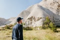 The man stands next to the beautiful rocks and admires the scenery in Cappadocia in Turkey. The landscape of Cappadocia Royalty Free Stock Photo