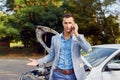 Man stands next to a broken car calling Royalty Free Stock Photo