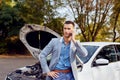 Man stands next to a broken car calling Royalty Free Stock Photo