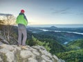 Man stands on the peak of rock. Hiker watching to autumn Sun at horizon . Beautiful moment Royalty Free Stock Photo