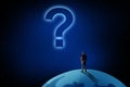 A man stands on the planet in front of a big question mark. The concept of solving the problem, searching for answers Royalty Free Stock Photo