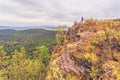 A mature male tourist stands on top of a mountain and admires the picturesque morning Ural view. Royalty Free Stock Photo