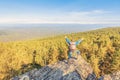 A man stands on a rock and opens his arms in breadth Royalty Free Stock Photo