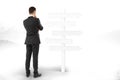 Man stands and thinks about blank signpost directions Royalty Free Stock Photo