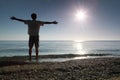 Man stands in water and conducts hands in sides Royalty Free Stock Photo