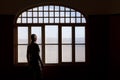 Man staring out a dirty window Royalty Free Stock Photo