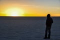 Man starring at the sunset in Salar de Uyuni, Bolivia