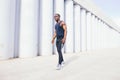 Side view of cut Black athlete sprinting on the street. Royalty Free Stock Photo