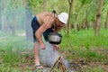 Man starting a cooking fire in a campsite