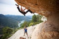 Man starting to climb challenging route