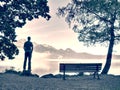 Man stay lonely at the bench in front of the lake Royalty Free Stock Photo