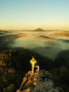 Man stay on the rocky peak and within daybreak wat Royalty Free Stock Photo