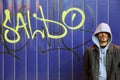 Man is staying near wall with graffiti in a street Royalty Free Stock Photo