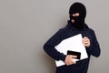 Man steals laptop and phone, runs away and turns back, being of persecution, wears robber mask and black turtleneck, advertising