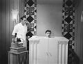 Man in steam bath with assistant and dictaphone