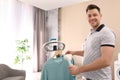 Man steaming his clothes on rack at home Royalty Free Stock Photo