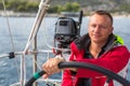 Man steers the controls of a sailing yacht boat. Sport. Royalty Free Stock Photo