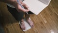 Man step on digital glass scales to check weight. Male weighting on floor scales in domestic room, close up feet view. Men s feet Royalty Free Stock Photo