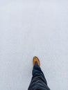 Man step forward on the white snowy ground