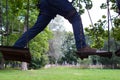 Man stepping from one wooden board to another Royalty Free Stock Photo