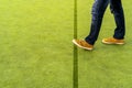 Man stepping over a line on a synthetic artificial turf